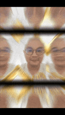 a blurry picture of a man with glasses and a gold ribbon around his face