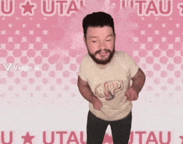 a man with a beard is dancing in front of a pink background that says utau