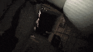 a person standing in a dark room with a light shining on them