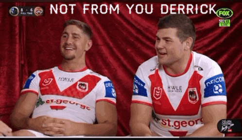 two rugby players are sitting in front of a red curtain with the words not from you derrick