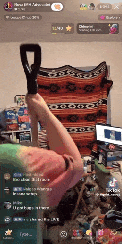 a person holding a vacuum cleaner in a messy room