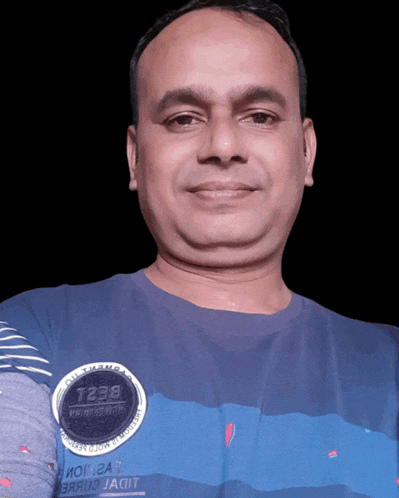 a man wearing a blue shirt with a badge that says t238
