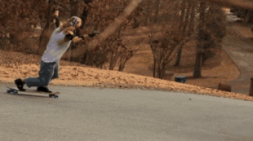 a person is riding a skateboard down a street