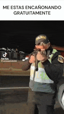 a police officer is holding a gun in front of a truck .