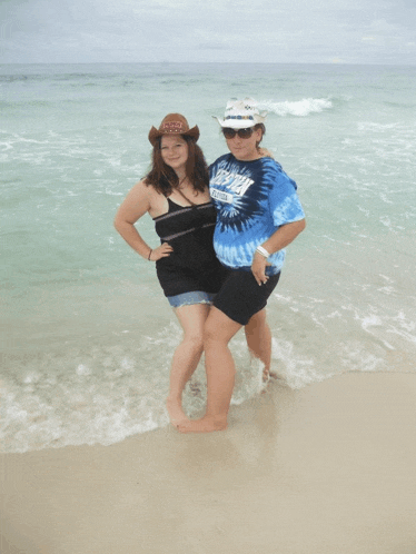 two women standing on a beach with one wearing a shirt that says texas