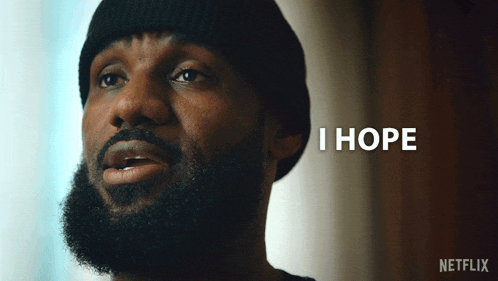 a man with a beard wearing a black beanie says " everything is okay "