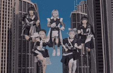a group of girls standing on top of a building