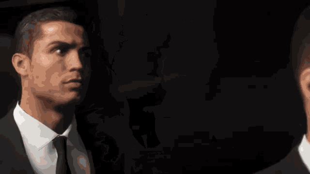 a man in a suit and tie is looking to the side