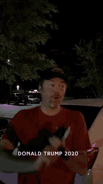 a man wearing a hat that says donald trump on it