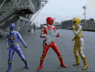 three power rangers are standing next to each other on the street