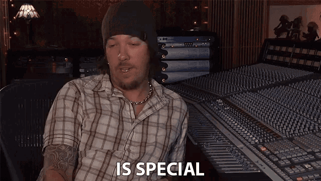 a man in a plaid shirt says " is special " in front of a mixer