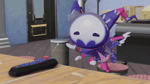 a remote control sits on a wooden table next to a cartoon character