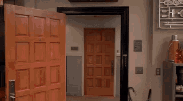 a woman is hanging upside down in a doorway in a room