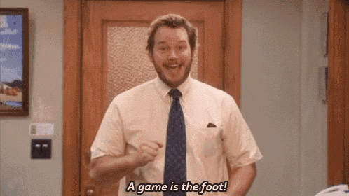 a man in a white shirt and blue tie is standing in a doorway and says a game is the foot .