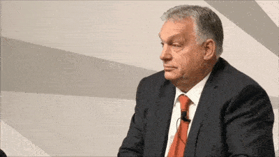 a man in a suit and tie with a microphone