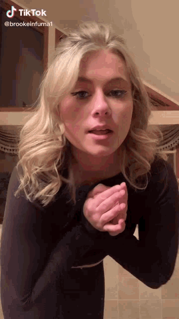 a woman 's face is shown in a tiktok video by brookeinfurna1