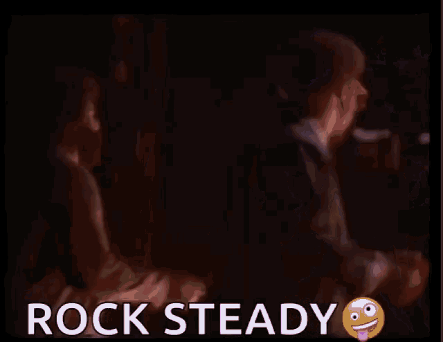 two men in suits are dancing on a stage with the words rock steady written on the bottom