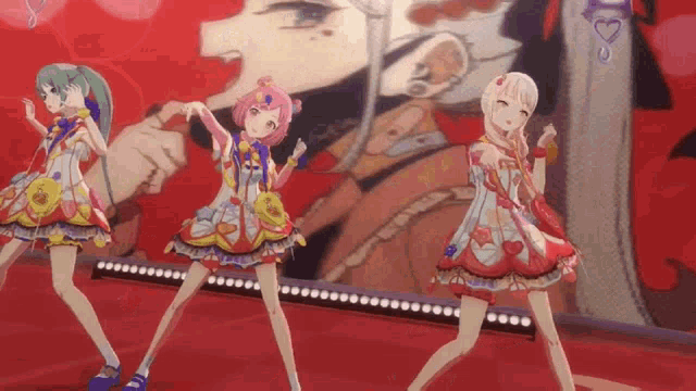 three anime girls are dancing on a stage in front of a red background .