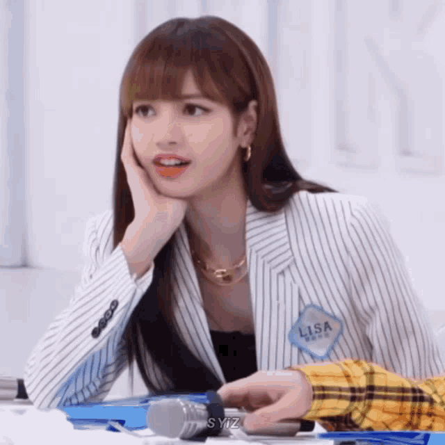 a woman wearing a striped jacket has a name tag that says lisa