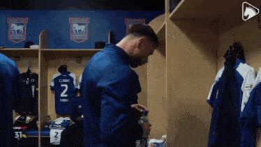 a man in a locker room with a jersey that says clarke on it