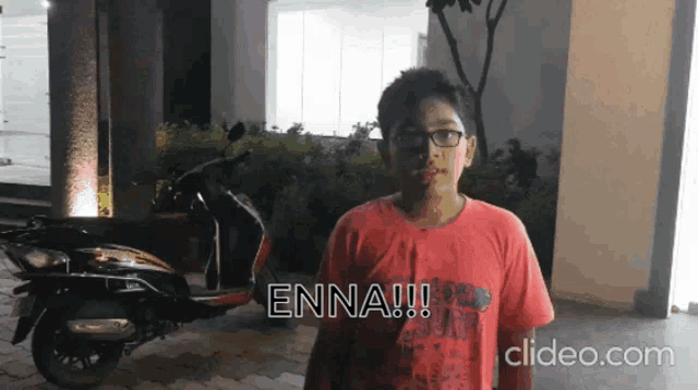 a boy in a red shirt with the word enna written on it