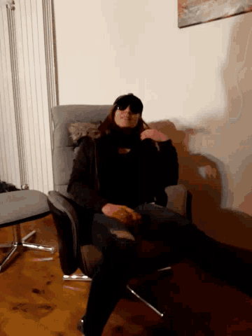 a woman sits in a chair with her feet up