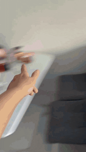 a blurry picture of a person 's hand reaching out towards something