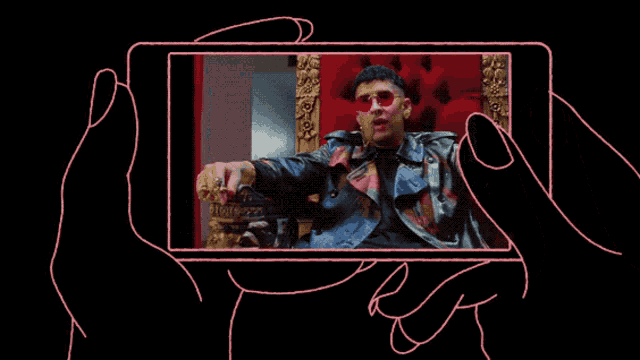 a person is holding a cell phone with a picture of a man in a chair on it
