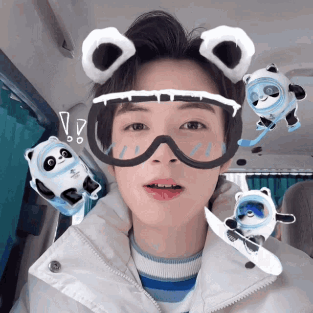 a person wearing a pair of ski goggles with a panda bear on them