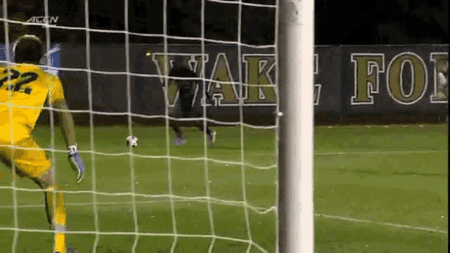 a soccer goalie with the number 22 on his shirt