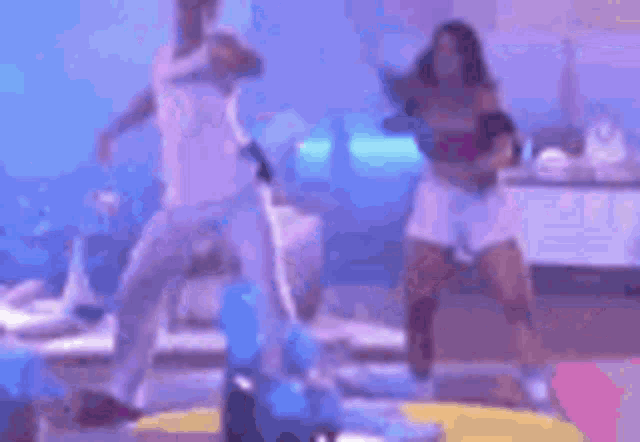a blurry picture of a group of people dancing on a stage in a nightclub .
