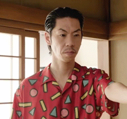 a man wearing a red shirt with geometric shapes on it