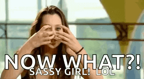 a woman is covering her eyes with her hands and the words `` now what ? ''