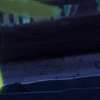 a green object is glowing in the dark in a dark room .