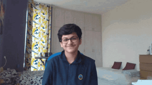 a young boy wearing glasses and a blue jacket has a badge on his chest that says ' army '
