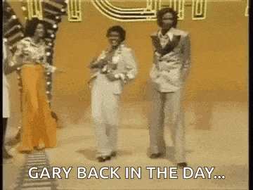 a group of people are dancing on a stage and the words `` gary back in the day '' are written on the screen .