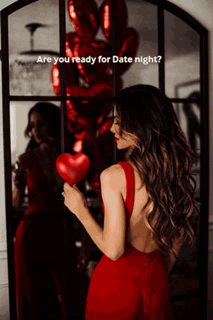 a woman in a red dress is holding a red heart in front of a mirror and the words are you ready for date night