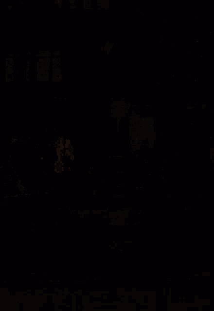 a person is standing in front of a bus stop at night .