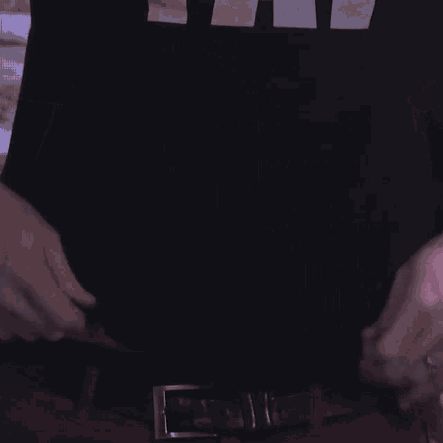 a man 's stomach is shown with a black shirt that says ' a ' on it