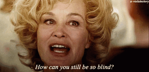 a close up of a woman asking how can you still be so blind