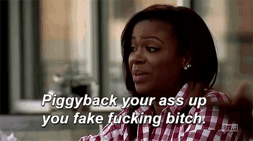 a woman in a plaid shirt is saying " piggyback your ass up you fake fucking bitch "