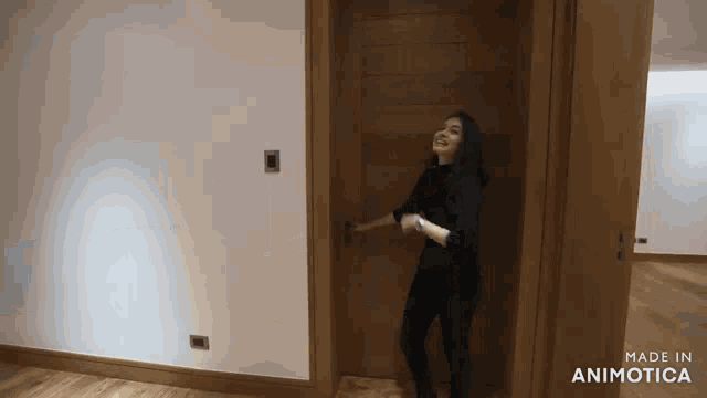 a woman is standing in a room with the words made in animatica on the bottom right