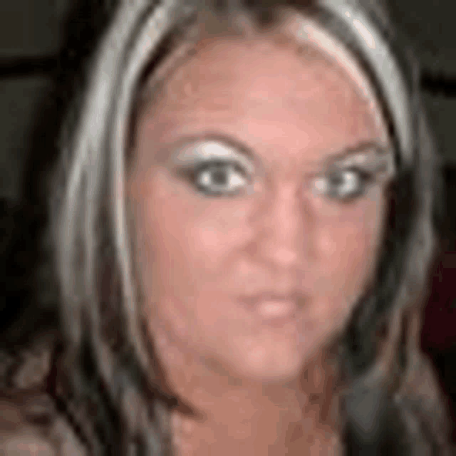 a close up of a woman 's face with a blurry background
