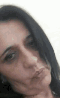 a close up of a woman making a funny face with her mouth open .