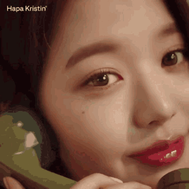 a close up of a woman 's face with the word hapa kristin visible