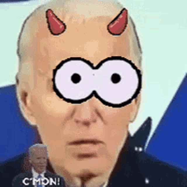 a close up of a man 's face with a cartoon face and horns on it .
