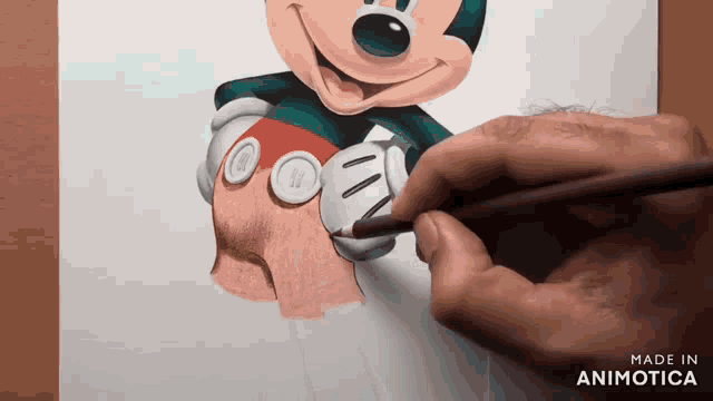 a person is drawing mickey mouse with a pencil