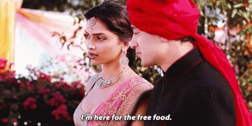 a man and a woman are standing next to each other and the woman is saying `` i 'm here for the free food ''