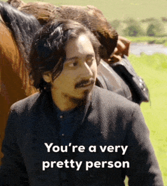 a man standing in front of a horse with the words you 're a very pretty person below him