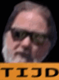 a man with glasses and a beard is holding a yellow sign that says tijd